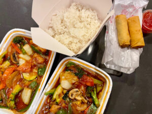 Two vegetable dishes with rice and fried spring rolls